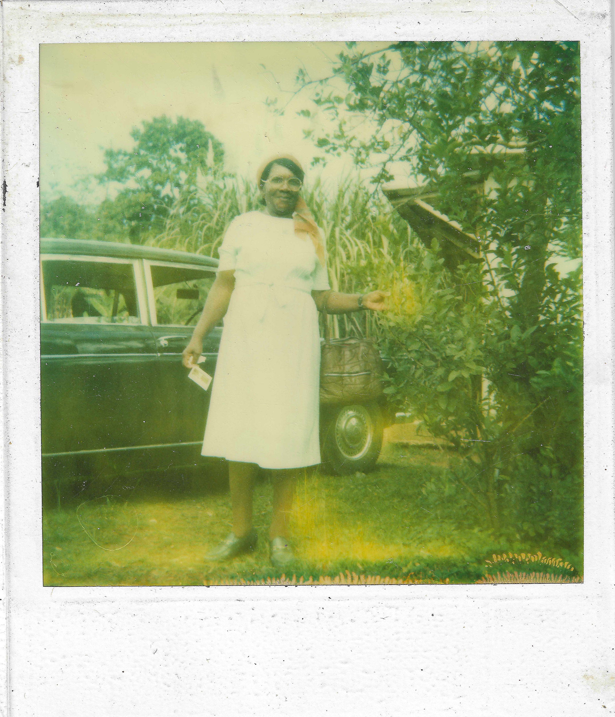 Woman standing in front of a car.